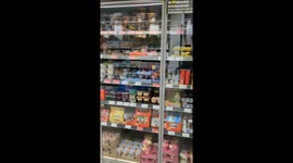 I walk along a milk product aisle in a grocery store in Hanover, Germany