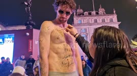 Man wearing just underpants freezes for art in Piccadilly Circus as passersby react to stunt