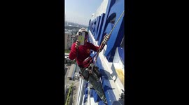Electricians abseil down building to repair shop's giant letters