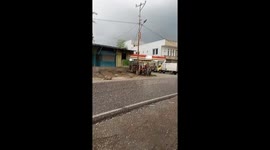 Marble-sized ice pellets rain down street in Indonesia