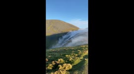 Rare sighting of clouds flowing over Skiddaw in England, UK