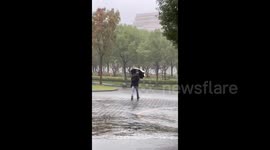 China: A Man Saves His Umbrella from Typhoon