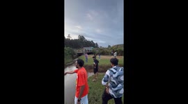 Person jumps over river but falls, getting muddy, in Tamil Nadu, India