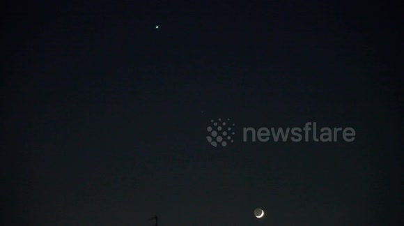 The Crescent Moon rises high in the sky over East London with Venus creating a beautiful celestial sight.