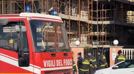 A fire truck with its flashing lights parked as a group of firefighters wait during an intervention on New Year's Day in Rome.