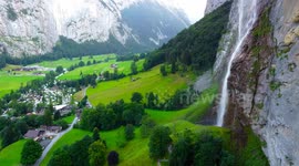Aerial view of Lauterbrunnen cityscape waterfall and grass from drone view in switzerland
