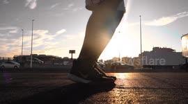 Sportsman rope skipping training in outdoor park at sunset focused on foot