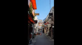 Quiet street in the middle of Shinjuku, Tokyo with a few passengers.