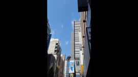 Godzilla watching over busy street in Shinjuku, Tokyo. Lively and busy town.