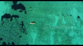 Kayak at the beach drone view. Kayaker fishing from aerial point of view at Mediterranean sea