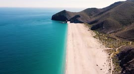 Seashore, coastline, scenic view of people at unspoiled beach in Almeria, called Playa de los Muertos, in English The beach of Deads due to the strong currents that cause many deaths year after year