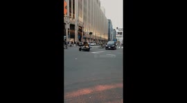 Group of people driving around in carts on a busy Shinjuku street on the weekend .