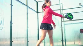 Murcia, Spain, December 2, 2024: Young mix match playing padel tennis in slow motion. Hitting padel ball in slow mo at padel court.