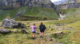Hikers walking down trail in Ordesa natural park, Spain