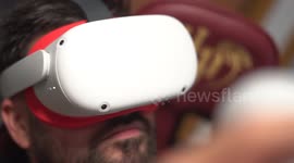 Young man watch virtual reality with VR glasses playing games at home.