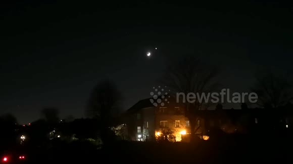 Crescent Moon and Venus seen over the Central Line in East London