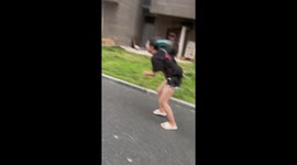 University student tries to walk through driving typhoon wind