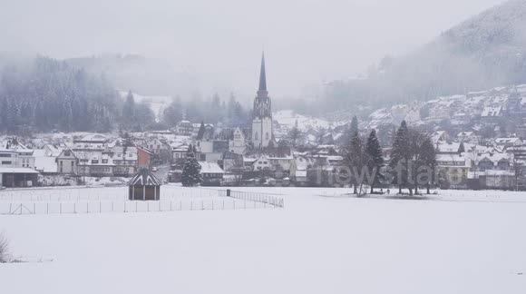 Beautiful small town in the Blackforest in winter fog at day time.