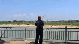 China: A Man Throw Himself Over the Railing During Fishing