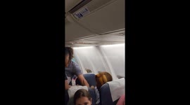 Passanger throws can of coke at flight attendant