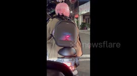 Woman has cool LED backpack featuring Demon Slayer anime
