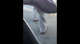 Winter woes: Young woman battles frozen shoes in China