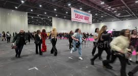 Members of the public rush into Dragcon UK on mass in an attempt to get a good viewing position on the Queens Catwalk