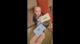 Luke is only 7 months old and grandma is trying to interest him with word cards but he’s anything but interested