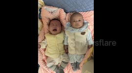 China: Two Babies with Completely Different Expressions
