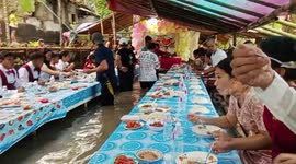 Wedding party relatives have water lapping at their feet during flood