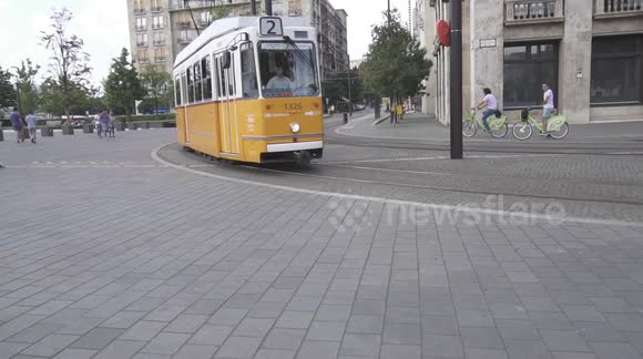 City train driving through Budapest in the afternoon near Hungarian Parliament.