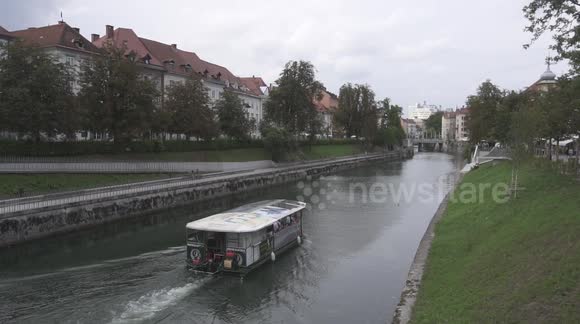 Tourist boat crossing the river in Ljubljana (Slovenia) at daytime.