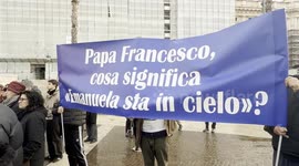 Two demonstrators hold up a banner with the slogan 'Pope Francis, what does it mean, Emanuela is in heaven?' during the sit-in to ask for the truth about the Orlandi case organized by her family in Rome.