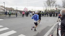 A man waves the Rainbow Families flag during the passage of the Miguel's Race organized by the Club Atletico Centrale in Rome.