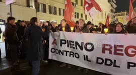 Demonstrators behind the banner with the slogan ‘at Full Regime against the DDL of fear' during the torchlight procession of protest against the approval of the Security Decree, the DDL 1660 on public safety, in Rome.