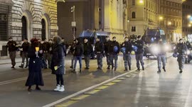 Police officers and two police vans follow the demonstrators during the torchlight procession of protest against the approval of the Security Decree, the DDL 1660 on public safety, in Rome.