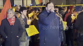 A protester speaks to other protesters during the torchlight procession of protest against the approval of the Security Decree, the DDL 1660 on public safety, in Rome.