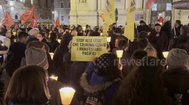 A sign with the slogan 'stop laws that criminalise peaceful protesters' is displayed during the torchlight procession of protest against the approval of the Security Decree, the DDL 1660 on public safety, in Rome.