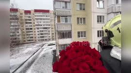 Fireman uses truck's crane to propose to girlfriend through her fourth floor window