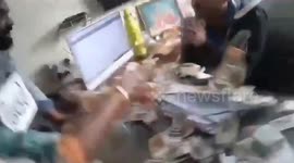 Furious taxpayers protest by throwing cash at 'corrupt' government staff