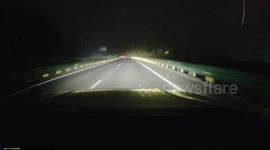 China: Folks Risk Danger to Move a Highway Obstacle