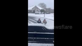 US Weather: Car Drags Sledding Kids On Snow
