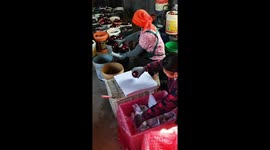 Fast-handed factory workers wrap eggplants at speed