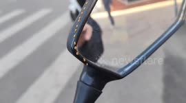 Bee leaves trail on motorcycle mirror in China