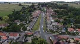 Coxwold, North Yorkshire, stock footage, aerial and passing cyclists in pretty English village