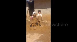 China:  Two Kids Playing in the Mud in Qiubei