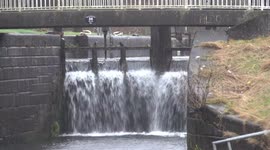 Storm Eowyn on the forth and clyde canal with fallen tree and waterfall spray