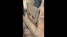 Otter reaches through enclosure holes to shake hands with zoo visitors