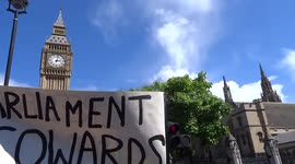 March for Europe protesters dance with Keep Corbyn and You xxx Our Future placards next to Parliament