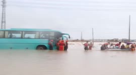 Firefighters rescue 50 bus passengers trapped by flood